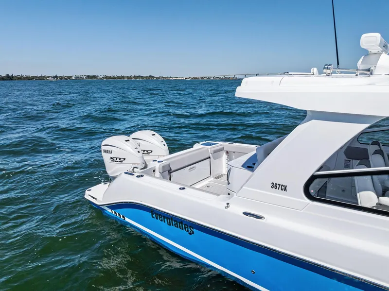 Slide: The Image of 2026 Everglades 367 CX boat cruising swiftly on open water. - 3
