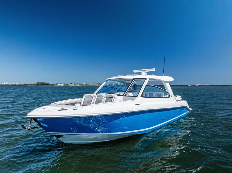 Slide: The Image of 2026 Everglades 367 CX boat cruising swiftly on open water. - 4