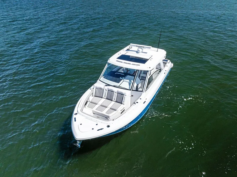 Slide: The Image of 2026 Everglades 367 CX boat cruising swiftly on open water. - 5