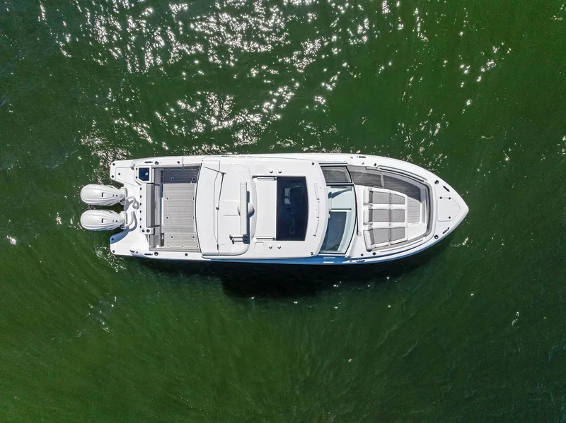 Slide: The Image of 2026 Everglades 367 CX boat on water, featuring sleek design and dual Mercury engines. - 6