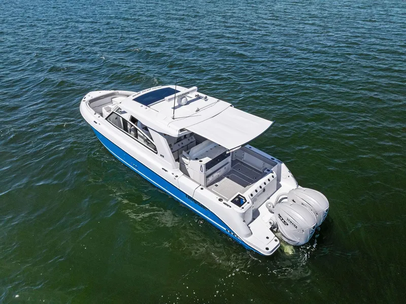 Slide: The Image of 2026 Everglades 367 CX boat with dual engines on calm water. - 7