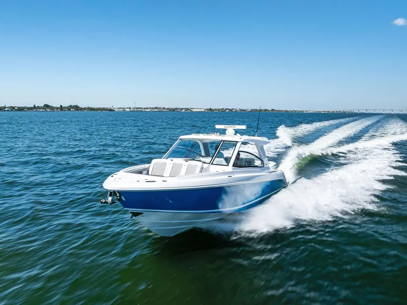 Slide: The Image of 2026 Everglades 367 CX boat on water, rear view with dual engines. - 9