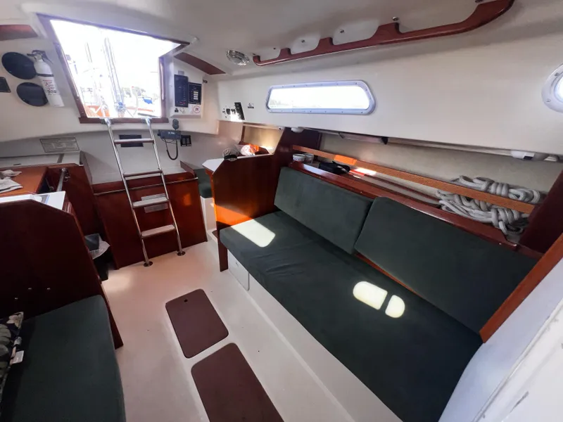 Slide: The Image of Interior of 1980 Pearson 32 sailboat with seating, ladder, and nautical equipment. - 13