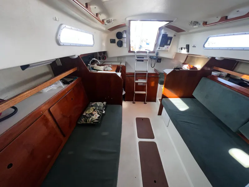 Slide: The Image of Interior of a 1980 Pearson 32 sailboat with wooden cabinetry and seating. - 14