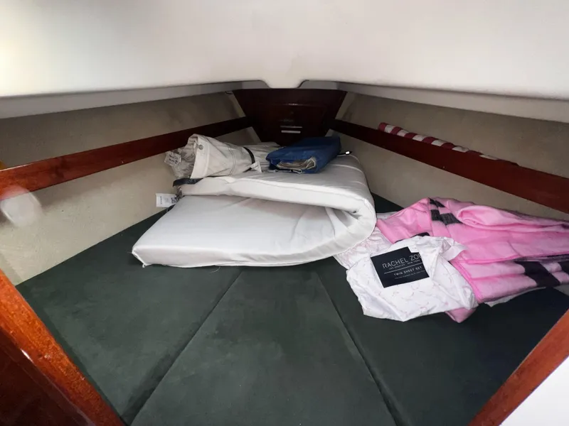 Slide: The Image of Cozy cabin interior of 1980 Pearson 32 sailboat with bedding and storage. - 17