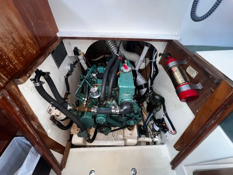 Slide: The Image of Engine compartment of a 1980 Pearson 32 sailboat with visible fire extinguisher. - 24