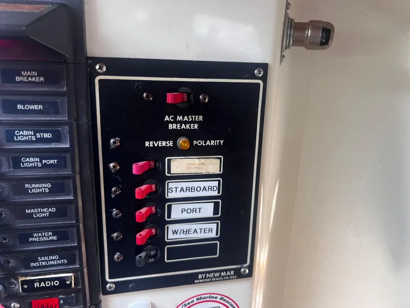 Slide: The Image of Electrical panel on a 1980 Pearson 32 boat with labeled switches and breakers. - 26