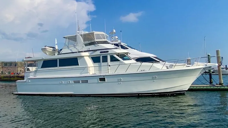 Slide: The Image of 1990 Hatteras 62 Cockpit Motor Yacht docked on a sunny day. - 0