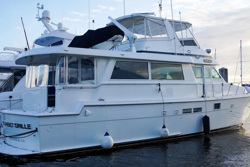 Slide: The Image of 1990 Hatteras 62 Cockpit Motor Yacht docked at marina, side view. - 1