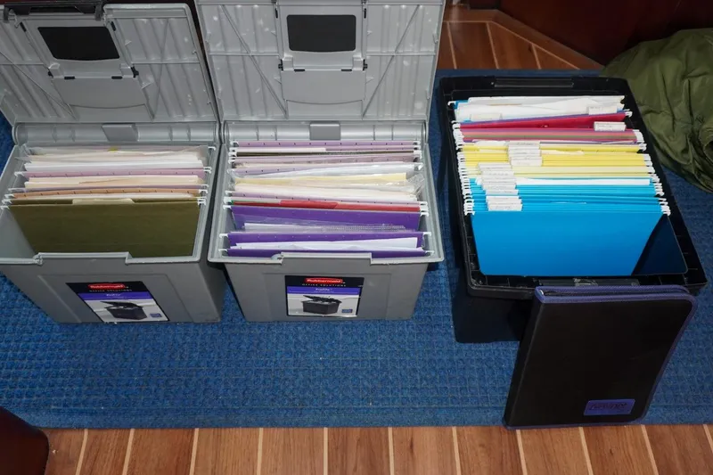 Slide: The Image of Organized file boxes with documents on a Hatteras 62 Cockpit Motor Yacht, 1990 model. - 18