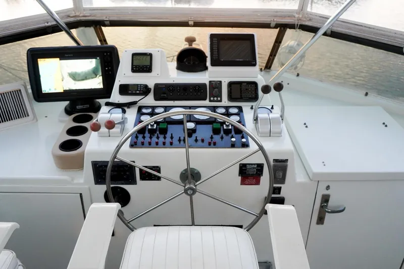 Slide: The Image of Cockpit of 1990 Hatteras 62 Cockpit Motor Yacht with navigation instruments and steering wheel. - 22