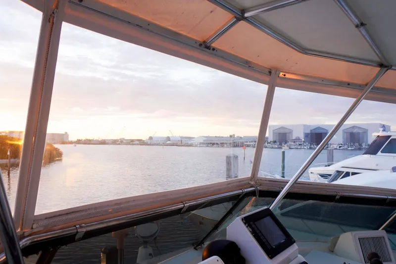 Slide: The Image of View from 1990 Hatteras 62 Cockpit Motor Yacht, overlooking marina at sunset. - 25