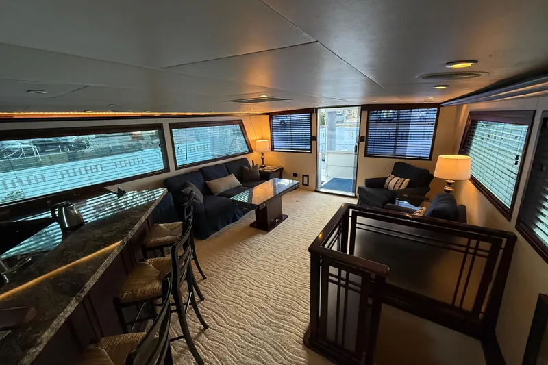 Slide: The Image of Luxurious interior of 1990 Hatteras 62 Cockpit Motor Yacht with elegant seating and large windows. - 31