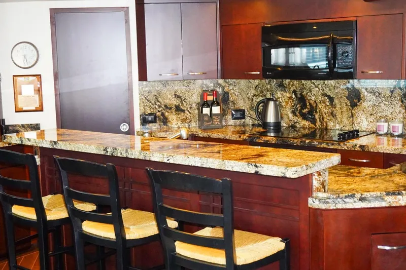Slide: The Image of Luxurious kitchen interior on 1990 Hatteras 62 Cockpit Motor Yacht with granite countertops. - 32