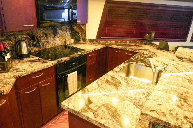 Slide: The Image of Luxurious kitchen in 1990 Hatteras 62 Cockpit Motor Yacht with granite countertops. - 34