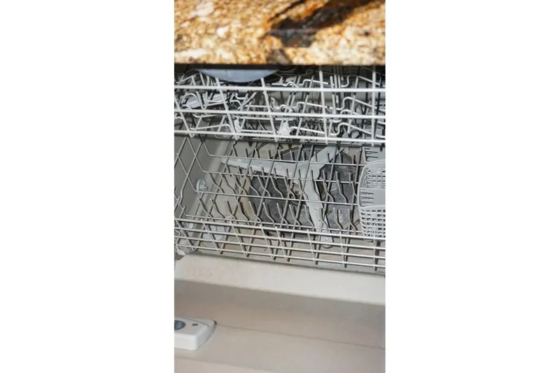 Slide: The Image of Open dishwasher with dishes inside, granite countertop above. - 37