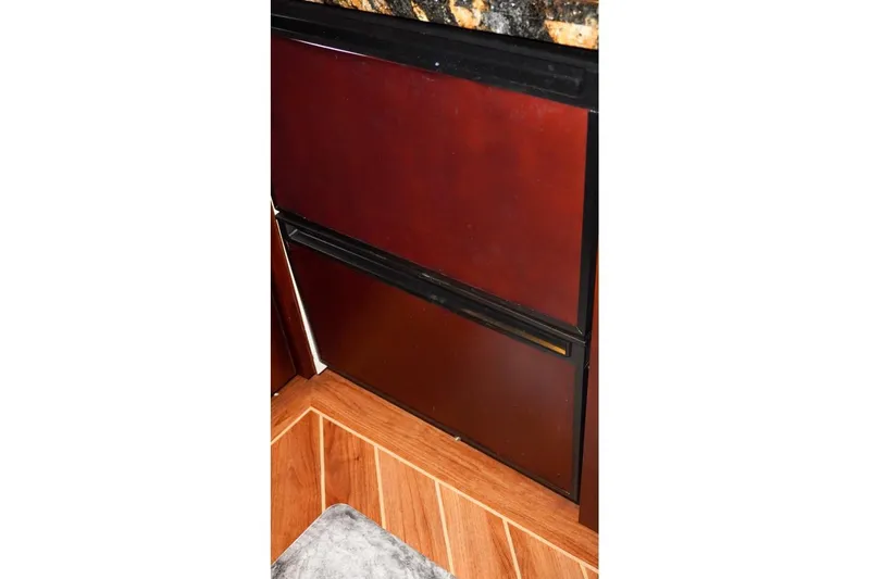 Slide: The Image of Interior of 1990 Hatteras 62 Cockpit Motor Yacht with wood paneling and granite countertop. - 38