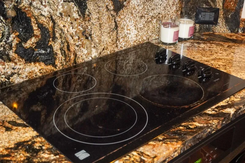 Slide: The Image of Granite countertop with electric cooktop on 1990 Hatteras 62 Cockpit Motor Yacht. - 40