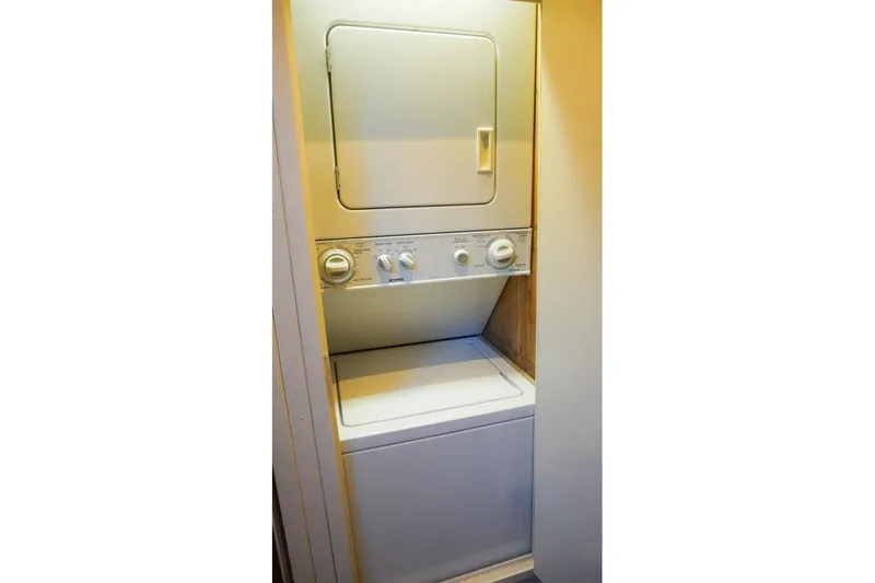 Slide: The Image of Stacked washer and dryer unit inside 1990 Hatteras 62 Cockpit Motor Yacht. - 45