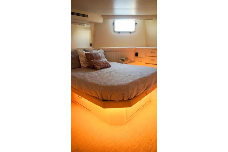 Slide: The Image of Luxurious bedroom interior of 1990 Hatteras 62 Cockpit Motor Yacht with ambient lighting. - 48