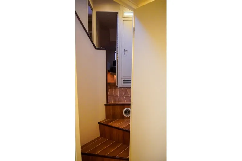 Slide: The Image of Interior staircase of 1990 Hatteras 62 Cockpit Motor Yacht with wooden steps. - 51