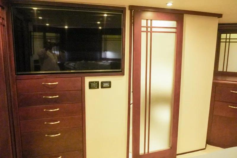 Slide: The Image of Luxurious interior of 1990 Hatteras 62 Cockpit Motor Yacht with TV and elegant cabinetry. - 55