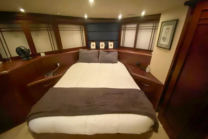 Slide: The Image of Luxurious bedroom interior of 1990 Hatteras 62 Cockpit Motor Yacht with cozy bedding. - 57