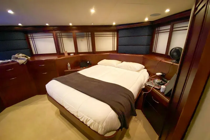 Slide: The Image of Luxurious bedroom interior of 1990 Hatteras 62 Cockpit Motor Yacht with elegant wood finishes. - 58
