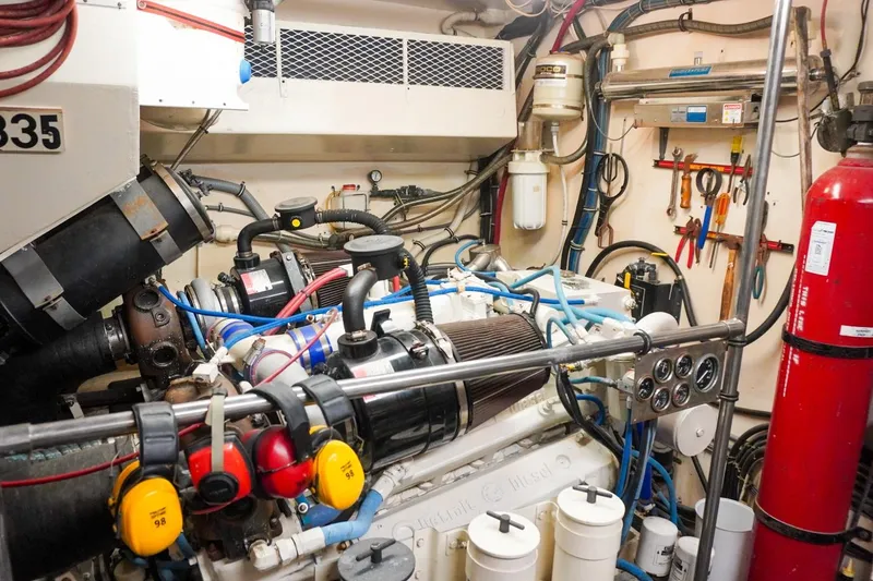 Slide: The Image of Engine room of a 1990 Hatteras 62 Cockpit Motor Yacht with tools and equipment. - 60