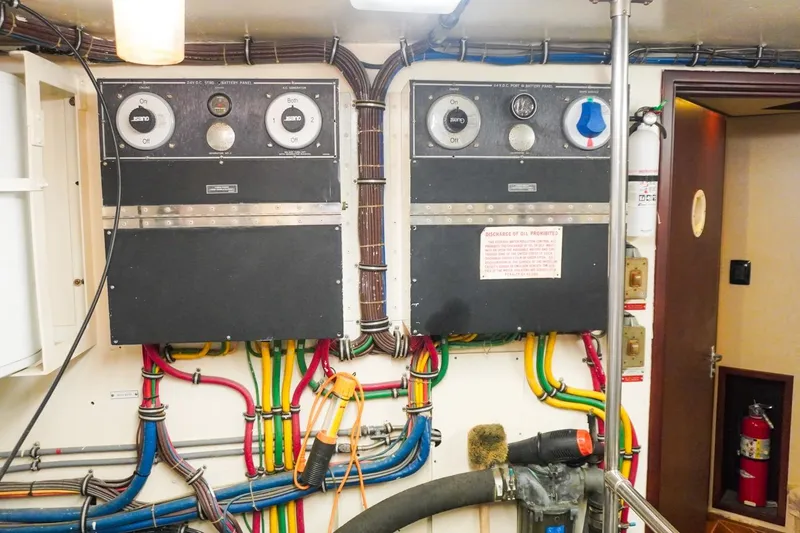 Slide: The Image of Electrical control panels and wiring in a 1990 Hatteras 62 Cockpit Motor Yacht engine room. - 61