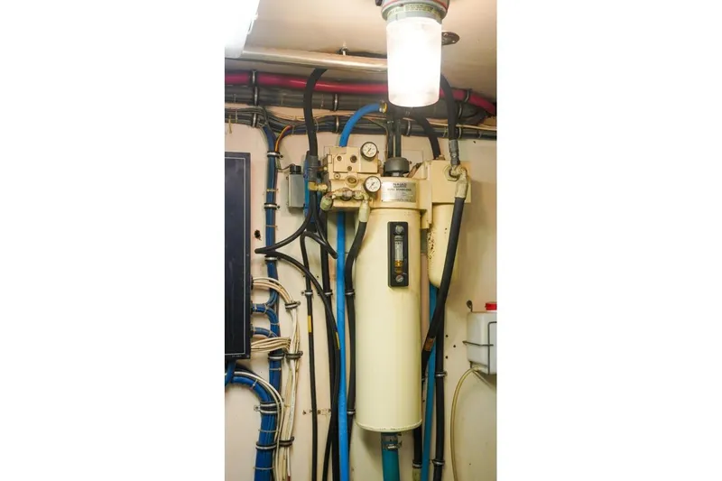 Slide: The Image of Engine room of 1990 Hatteras 62 Cockpit Motor Yacht with mechanical equipment and wiring. - 65