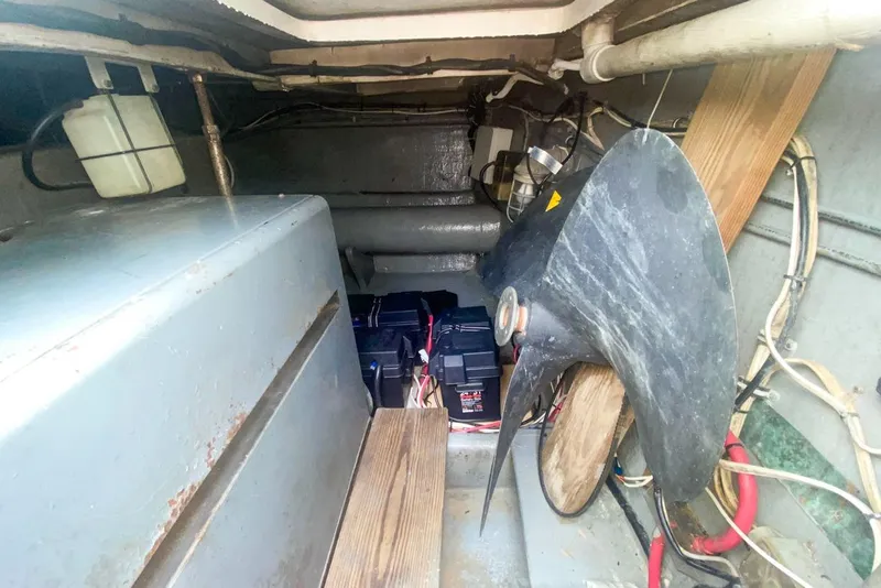 Slide: The Image of Engine room of 1990 Hatteras 62 Cockpit Motor Yacht with batteries and propeller. - 68