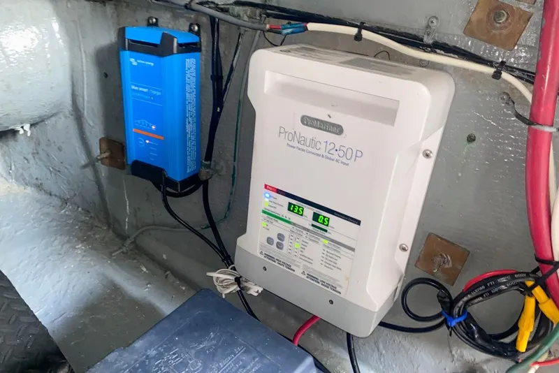 Slide: The Image of Electrical system inside a 1990 Hatteras 62 Cockpit Motor Yacht, featuring ProNautic charger. - 69