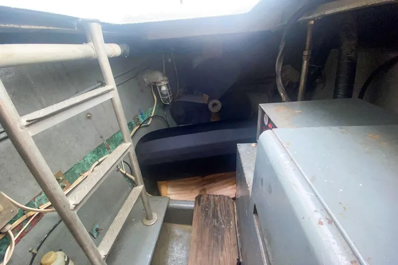 Slide: The Image of Engine room of 1990 Hatteras 62 Cockpit Motor Yacht with ladder and equipment. - 71