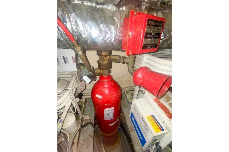 Slide: The Image of Engine room of 1990 Hatteras 62 Cockpit Motor Yacht with fire suppression system. - 72