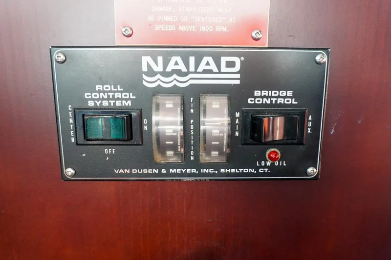 Slide: The Image of Control panel of a 1990 Hatteras 62 Cockpit Motor Yacht, featuring Naiad roll control system. - 74