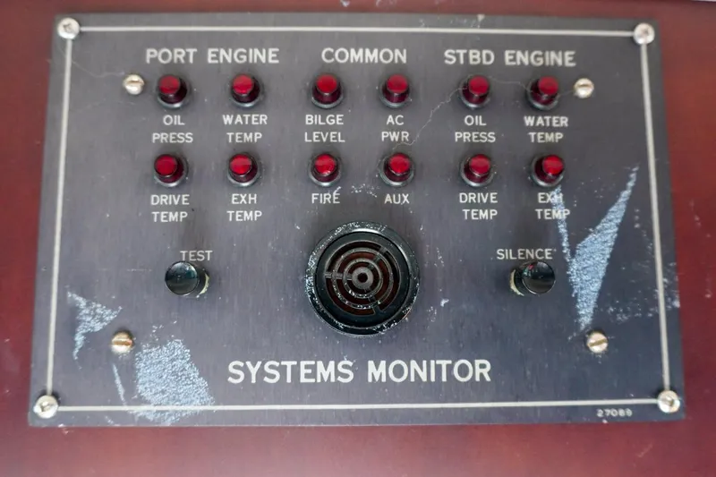 Slide: The Image of 1990 Hatteras 62 Cockpit Motor Yacht systems monitor panel with engine indicators. - 75