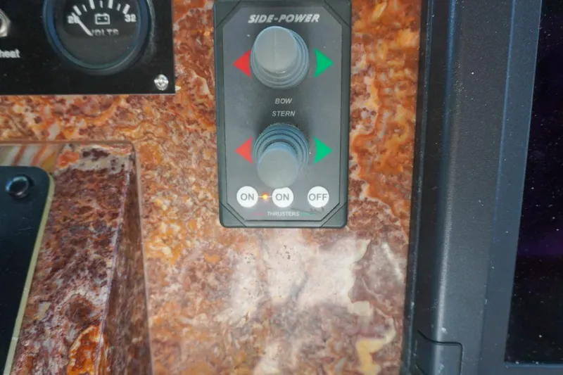 Slide: The Image of Control panel of a 1990 Hatteras 62 Cockpit Motor Yacht with bow and stern thrusters. - 76
