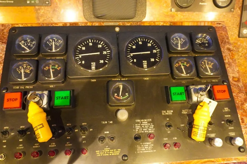 Slide: The Image of Control panel of a 1990 Hatteras 62 Cockpit Motor Yacht with gauges and switches. - 78