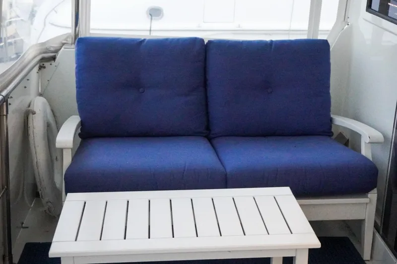Slide: The Image of Blue cushioned seating on 1990 Hatteras 62 Cockpit Motor Yacht deck. - 79