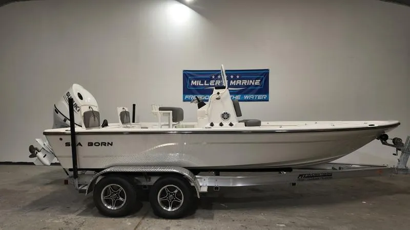 Slide: The Image of 2025 Sea Born FX 21 BAY boat on trailer in showroom. - 0