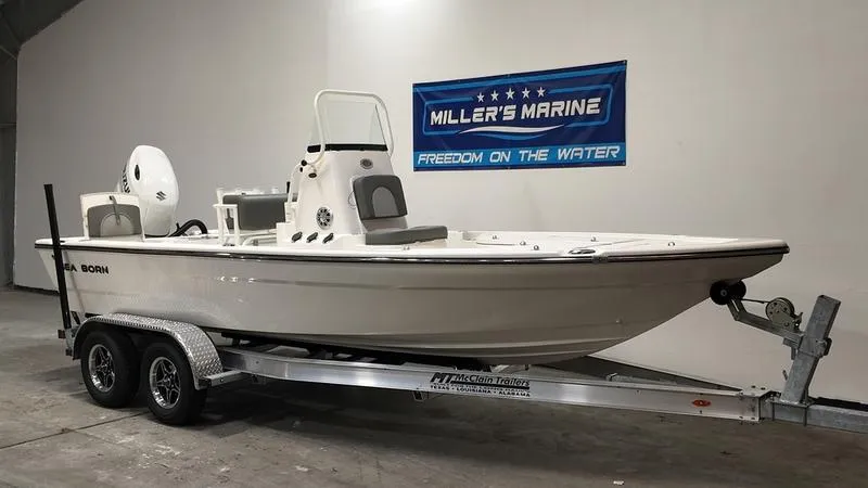 Slide: The Image of 2025 Sea Born FX 21 BAY boat on trailer at Miller's Marine showroom. - 1
