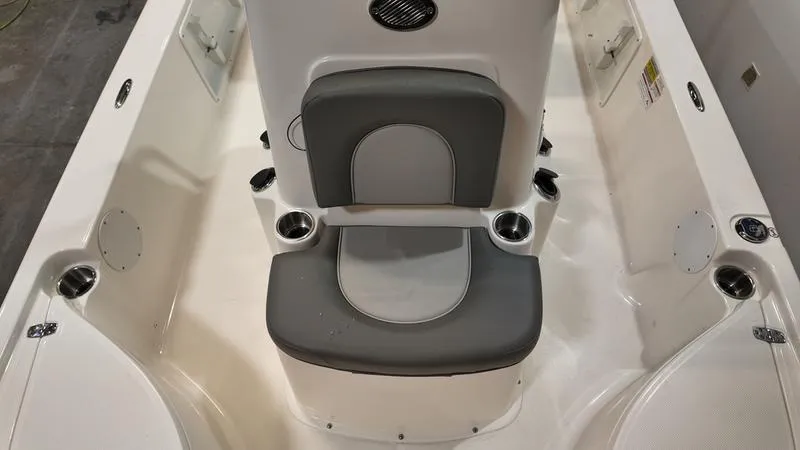 Slide: The Image of 2025 Sea Born FX 21 BAY boat interior with gray seating and cup holders. - 17