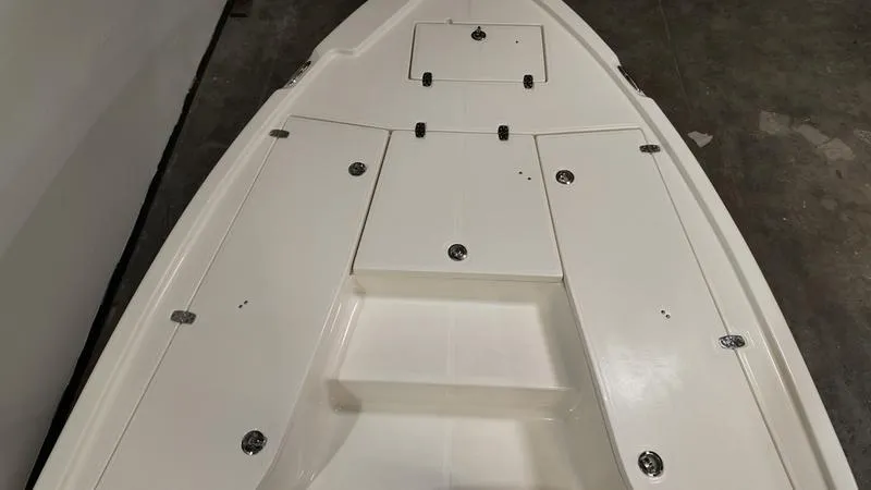 Slide: The Image of 2025 Sea Born FX 21 BAY boat deck, featuring storage compartments and sleek design. - 19