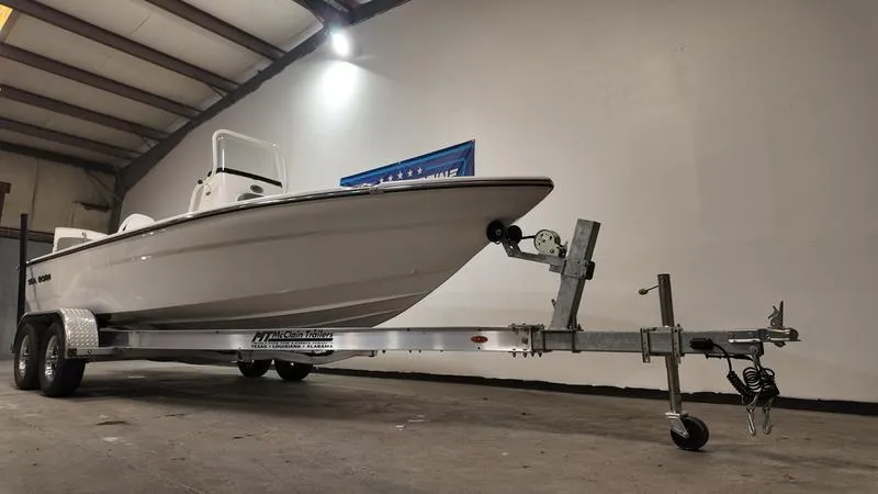 Slide: The Image of 2025 Sea Born FX 21 BAY boat on trailer in indoor storage facility. - 2