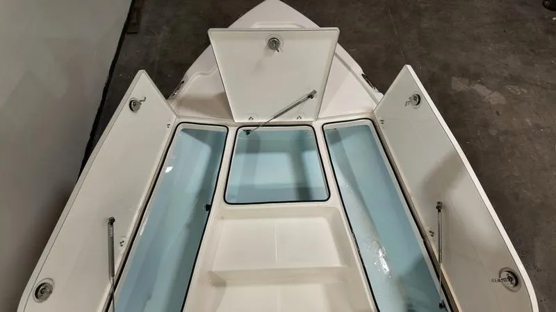 Slide: The Image of 2025 Sea Born FX 21 BAY boat storage compartments open, showcasing spacious design. - 20