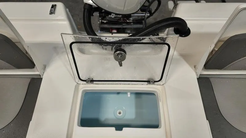 Slide: The Image of 2025 Sea Born FX 21 BAY boat with open livewell and motor view. - 7