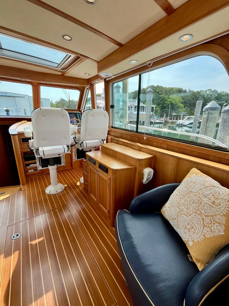 Slide: The Image of Interior of 2010 Sabre 40 Sedan yacht with wooden flooring and plush seating. - 15