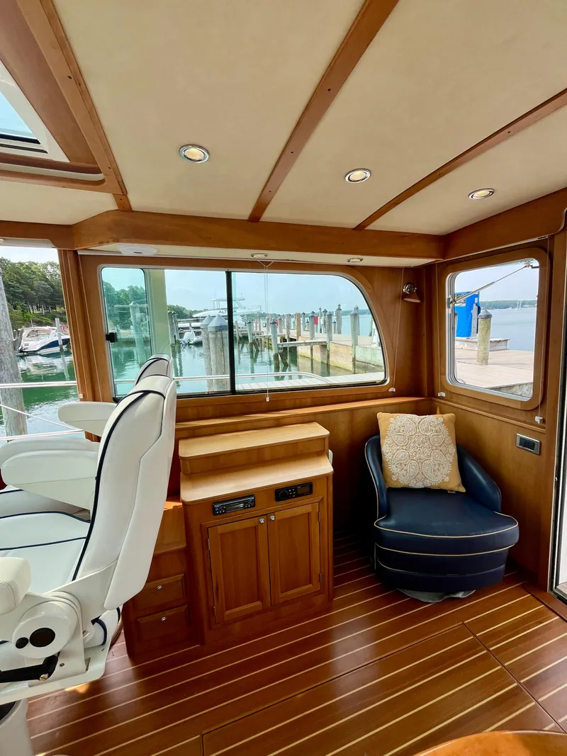 Slide: The Image of Interior of 2010 Sabre 40 Sedan yacht with wood finish and marina view. - 18