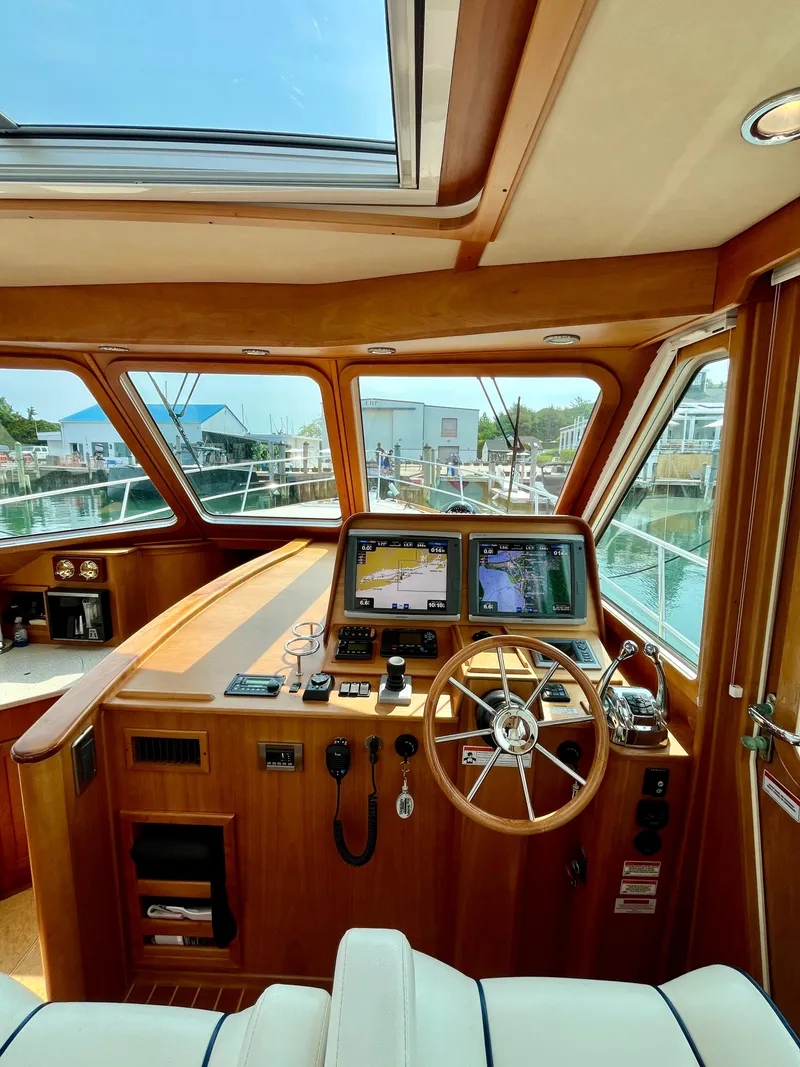 Slide: The Image of Interior of 2010 Sabre 40 Sedan yacht with navigation equipment and wooden steering wheel. - 21